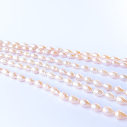 Smooth pink freshwater pearls in baroque oval shape, ideal handmade jewellery components with soft glow.