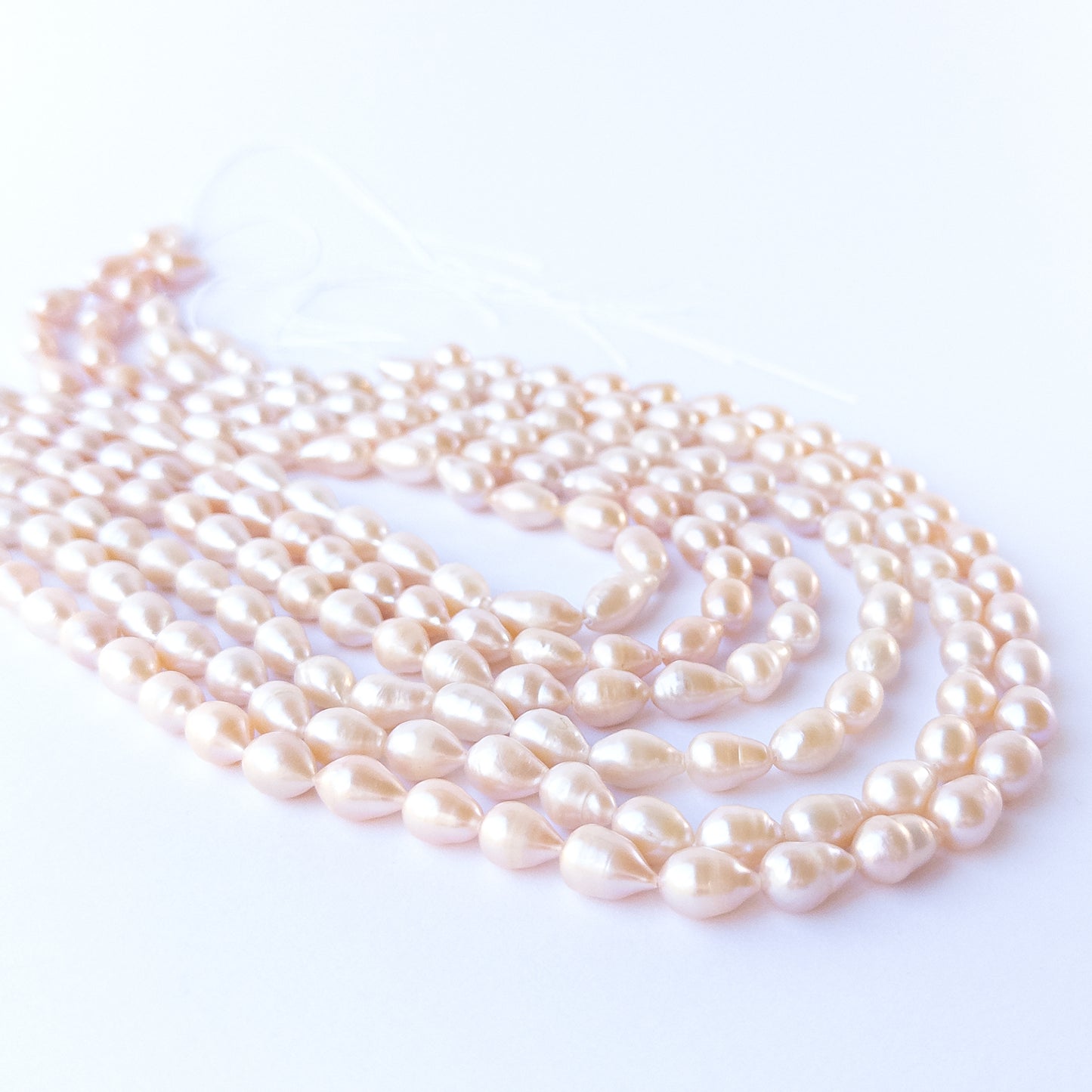 Authentic pink freshwater pearls, 7.5–8mm baroque oval beads offering natural lustre and organic charm.