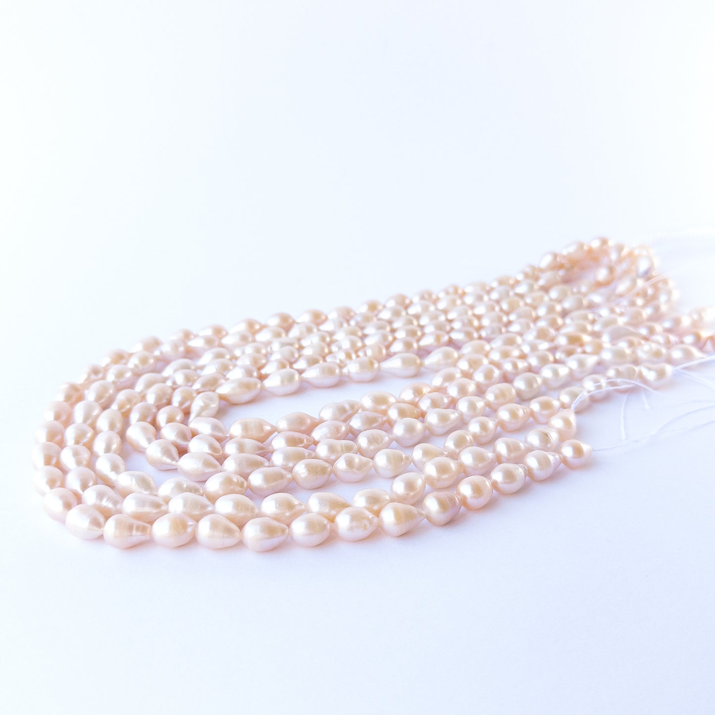 Genuine pink baroque oval pearls arranged on a 40cm strand, showcasing elegant shine and quality.
