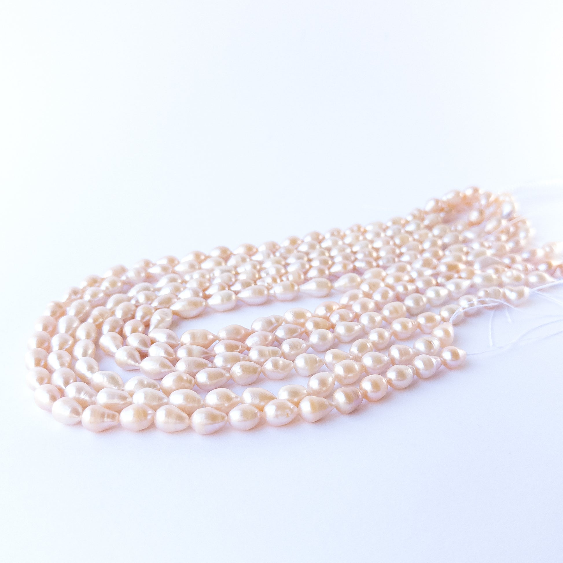 Genuine pink baroque oval pearls arranged on a 40cm strand, showcasing elegant shine and quality.