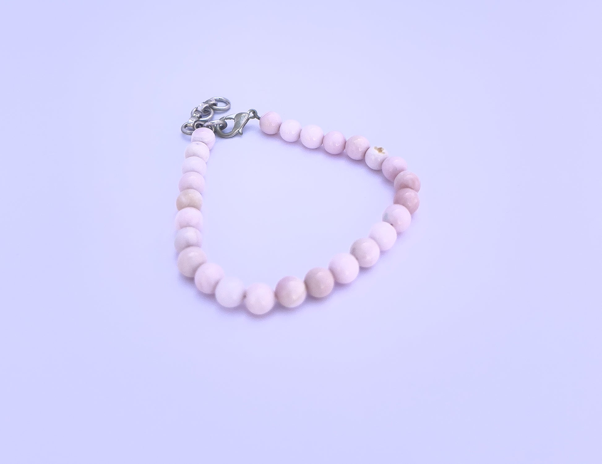 Close-up of natural gemstone beads showcasing vibrant multi-colour sparkle.
