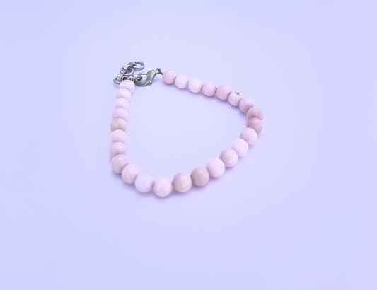 Close-up of natural gemstone beads showcasing vibrant multi-colour sparkle.
