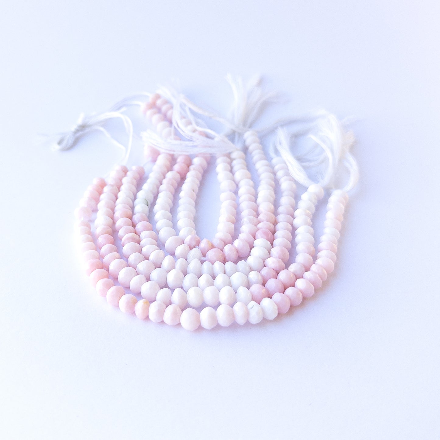 High‑quality pink opal rondelle gemstone beads with gentle shine and natural pastel colour variation.