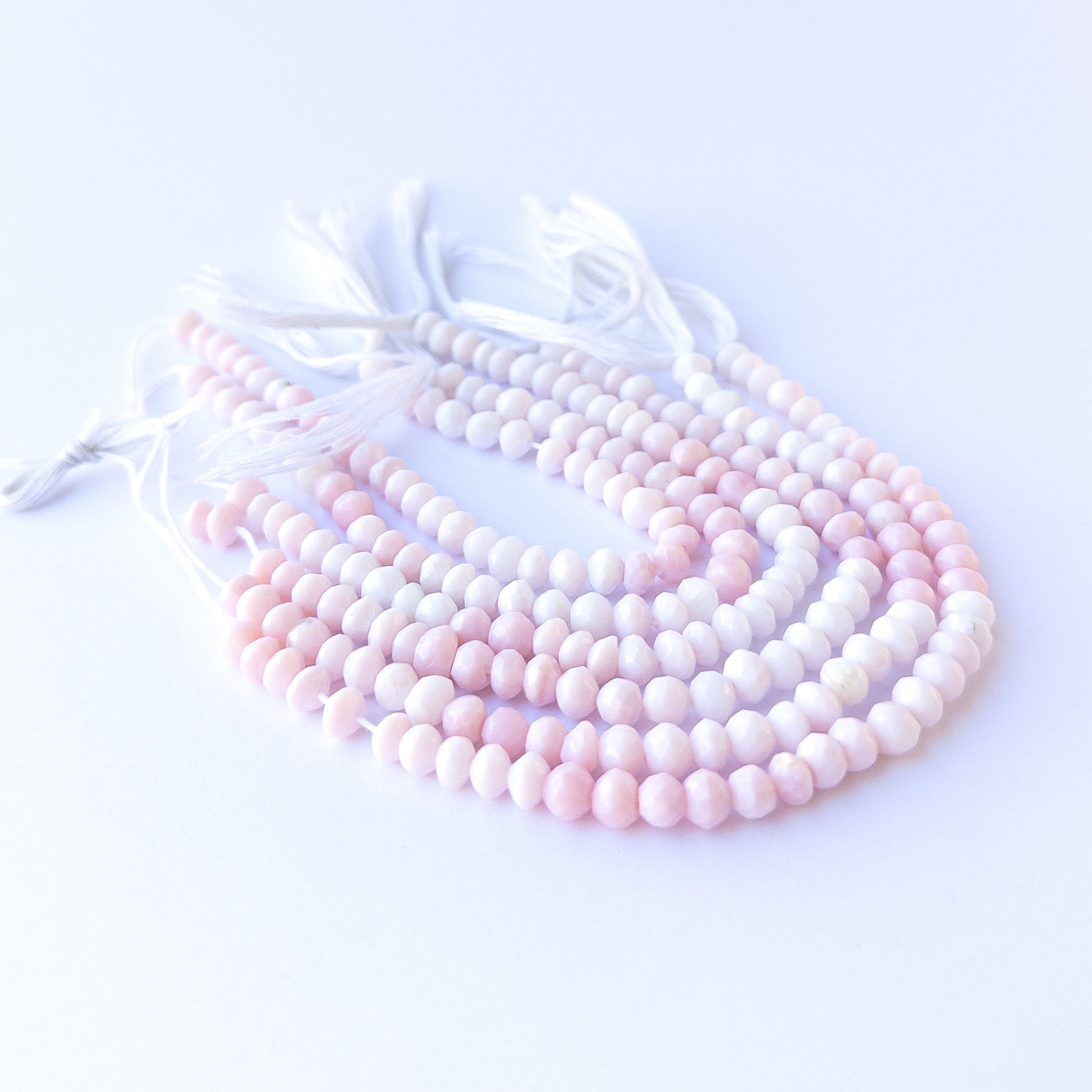 Authentic pink opal gemstone beads with shimmering faceted rondelle cuts, ideal for handmade jewellery components.
