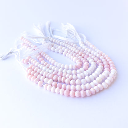 Authentic pink opal gemstone beads with shimmering faceted rondelle cuts, ideal for handmade jewellery components.
