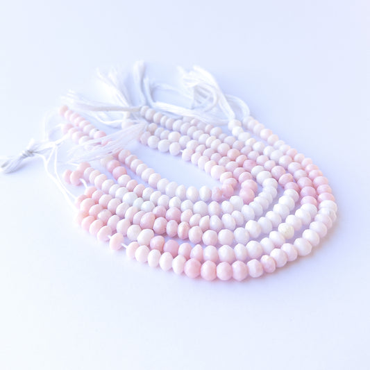 Authentic pink opal gemstone beads with shimmering faceted rondelle cuts, ideal for handmade jewellery components.