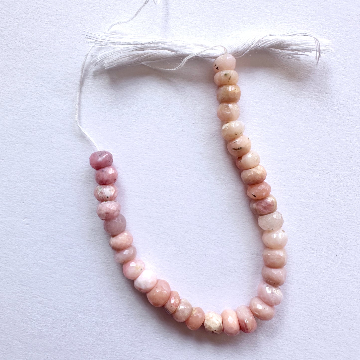 Stone beads featuring Pink Opal rondelles with high clarity and polished finish for jewellery making.
