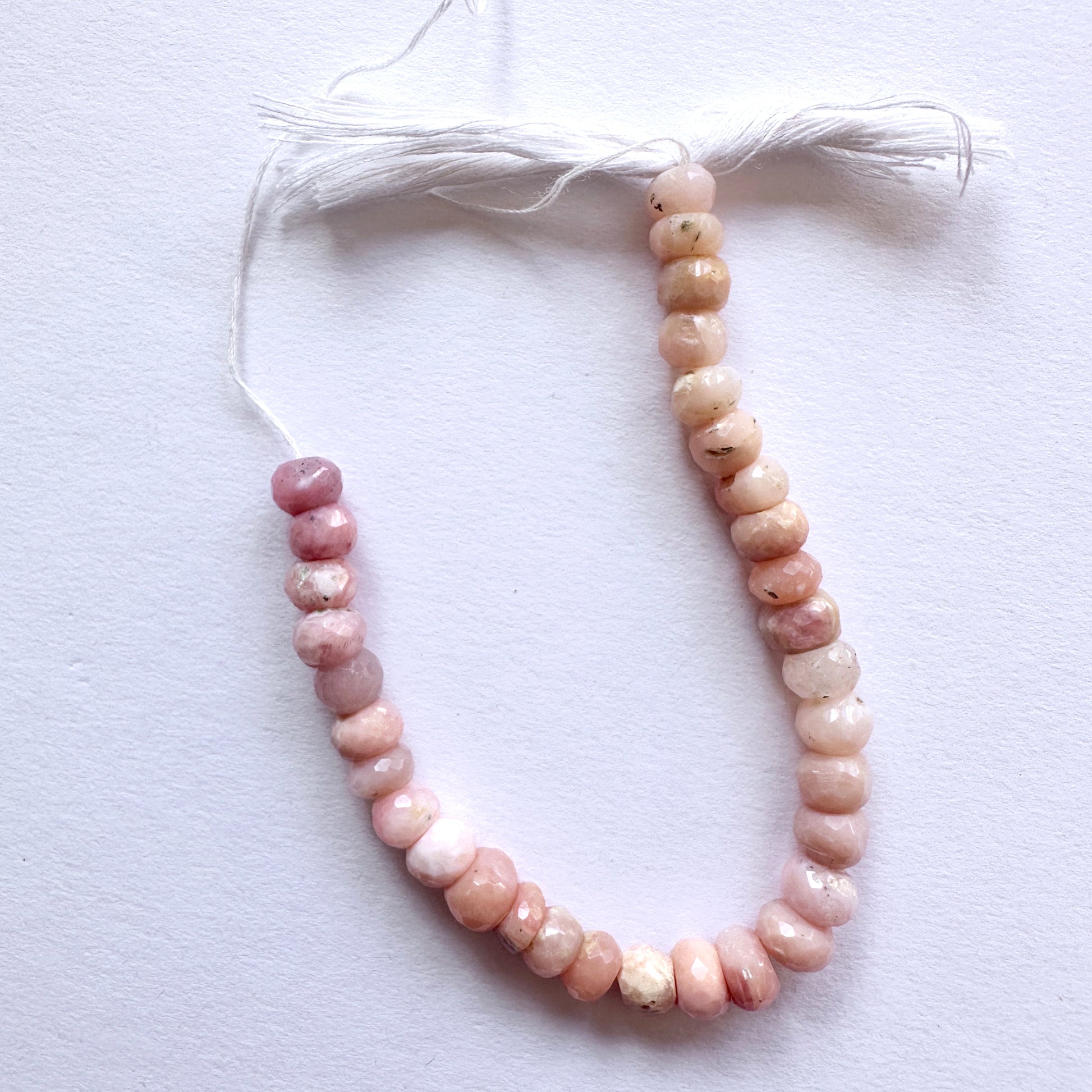 Stone beads featuring Pink Opal rondelles with high clarity and polished finish for jewellery making.
