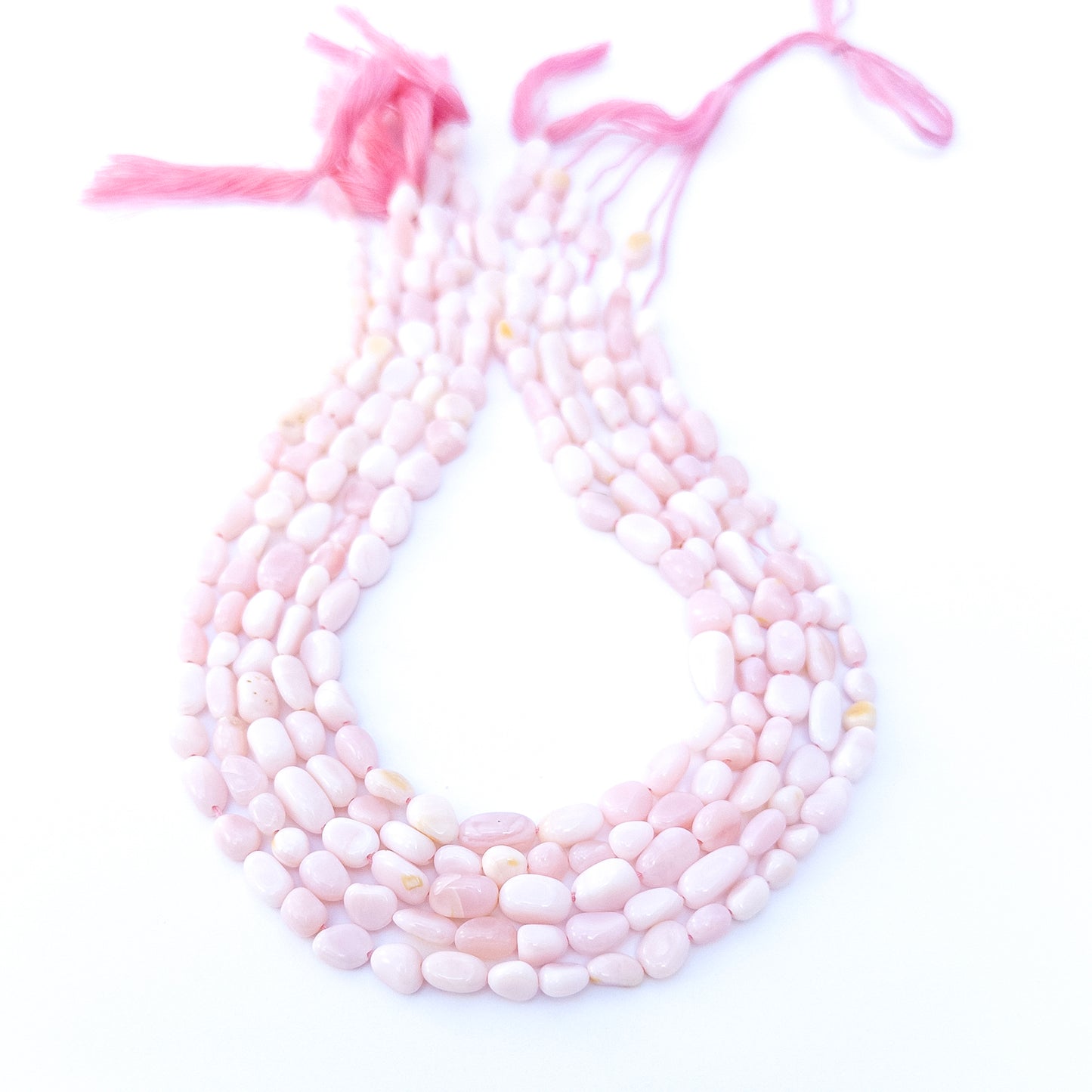 Pink Opal smooth tumble gemstone beads in soft blush tones arranged in a 31cm strand with gentle shine.