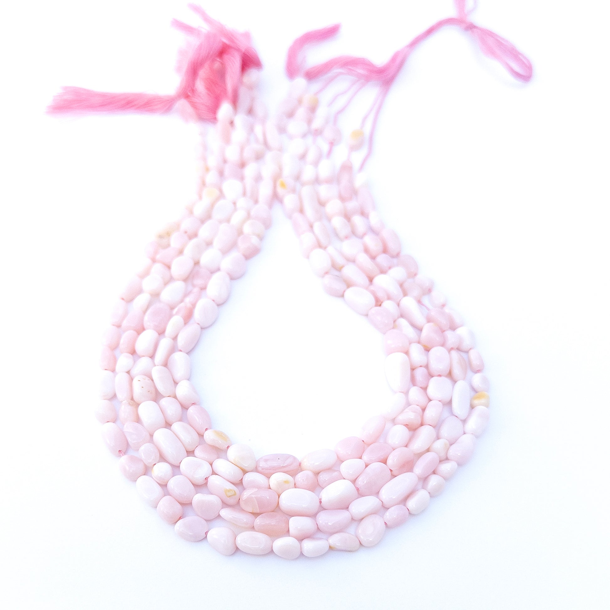 Pink Opal smooth tumble gemstone beads in soft blush tones arranged in a 31cm strand with gentle shine.