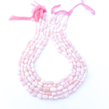 Pink Opal smooth tumble gemstone beads in soft blush tones arranged in a 31cm strand with gentle shine.