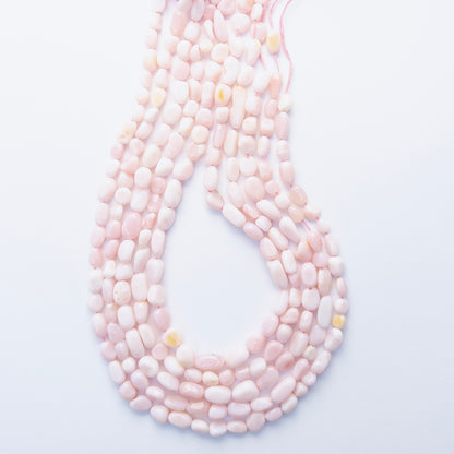 Close‑up of Pink Opal tumble gemstone beads highlighting their warm blush hues and smooth finish.