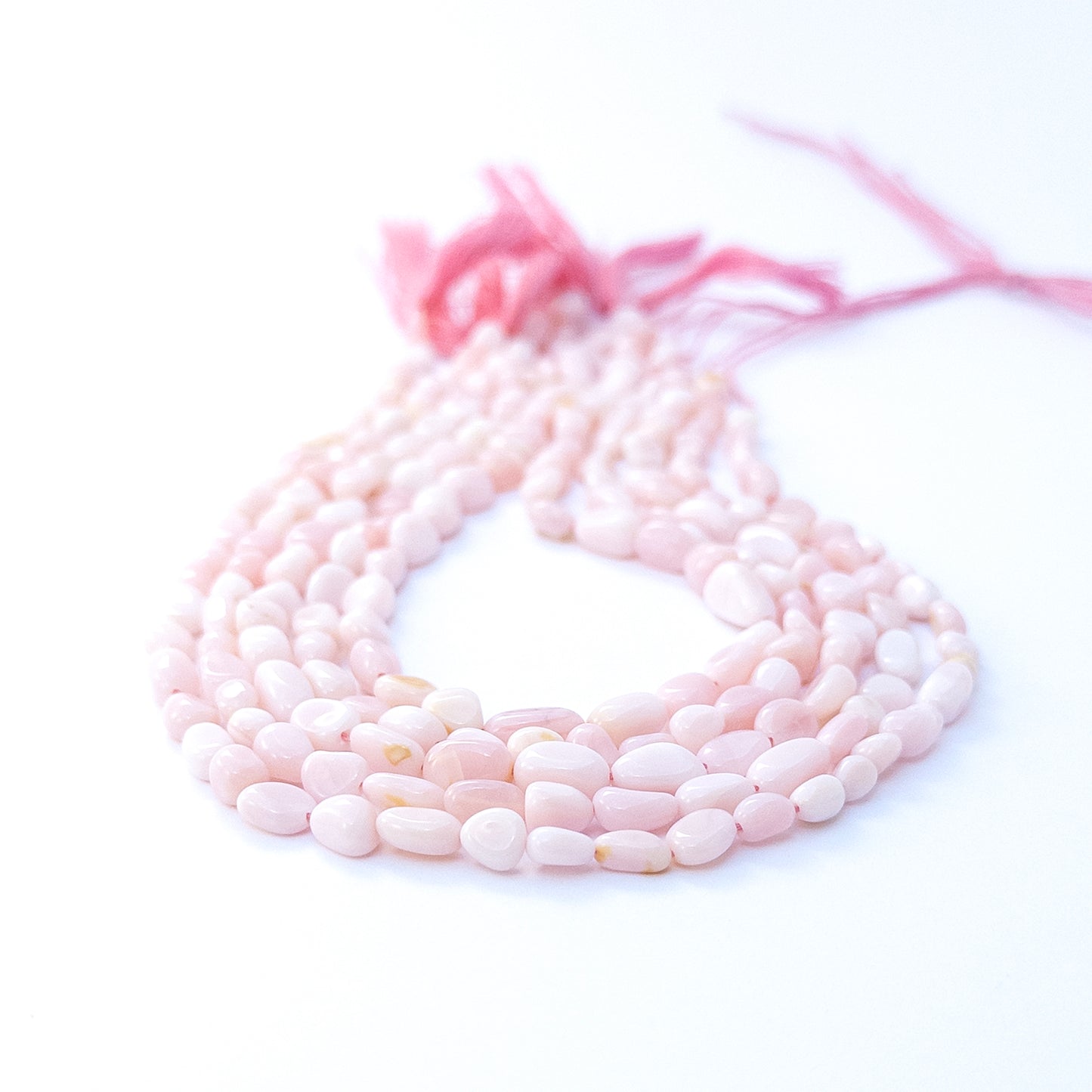 Handmade jewellery components featuring Pink Opal tumble beads with subtle shine and natural charm.