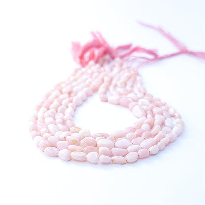 Handmade jewellery components featuring Pink Opal tumble beads with subtle shine and natural charm.