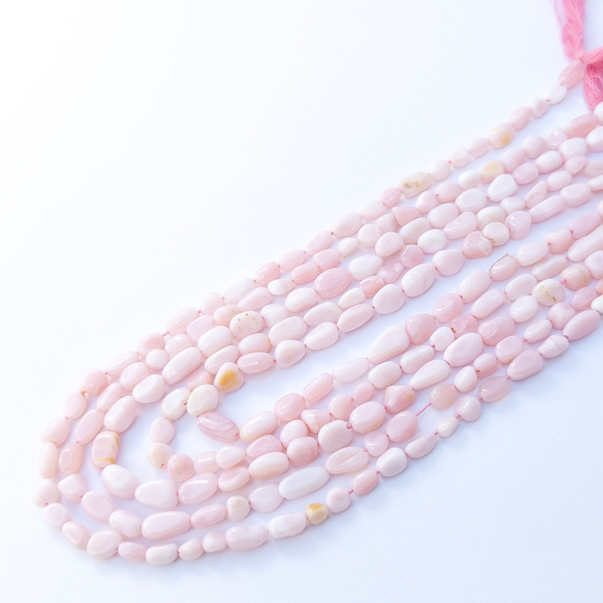 Genuine Pink Opal smooth tumble beads with soft shimmer, ideal for handmade jewellery components.