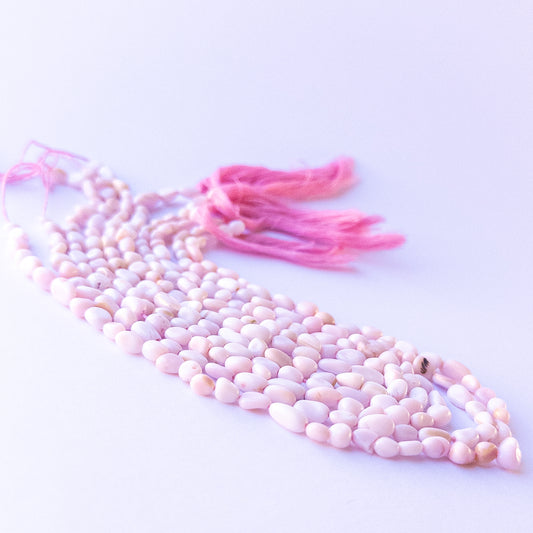 Authentic pink opal stone beads in polished smooth tumble cuts showing gentle blush colour for jewellery design work.