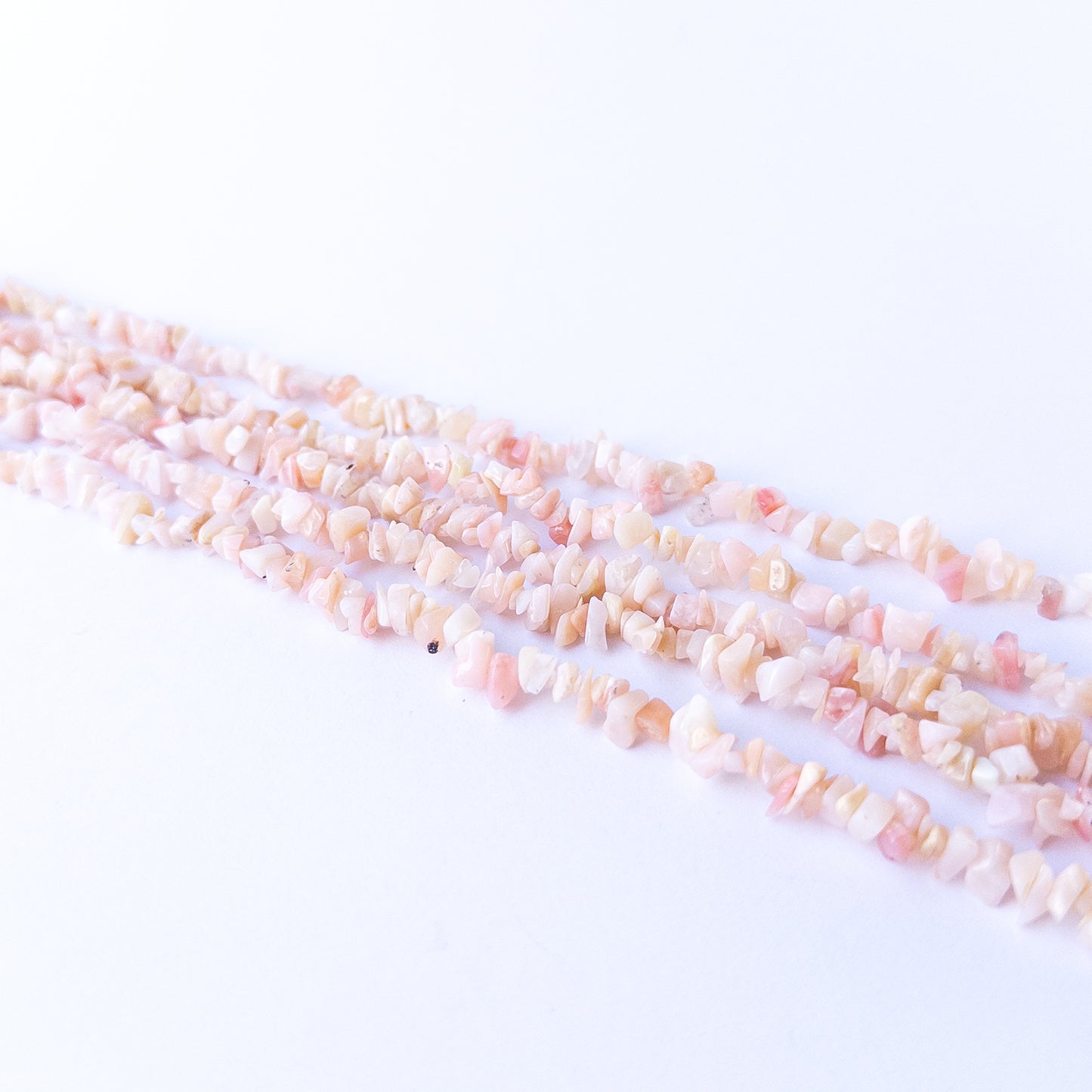 Handmade jewellery components featuring Pink Peruvian Opal chip beads with calming pastel tones.