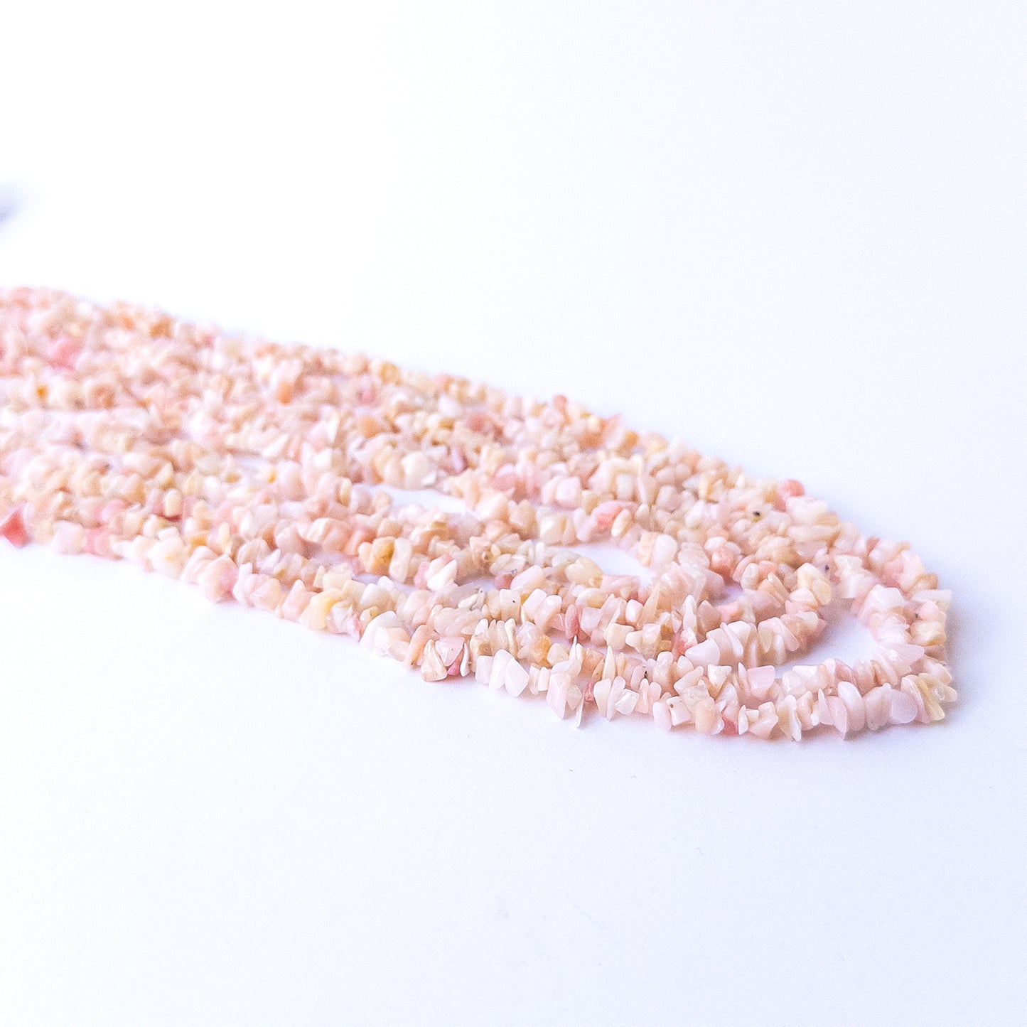Authentic Pink Peruvian Opal chip beads featuring organic shapes and soothing pink hues.