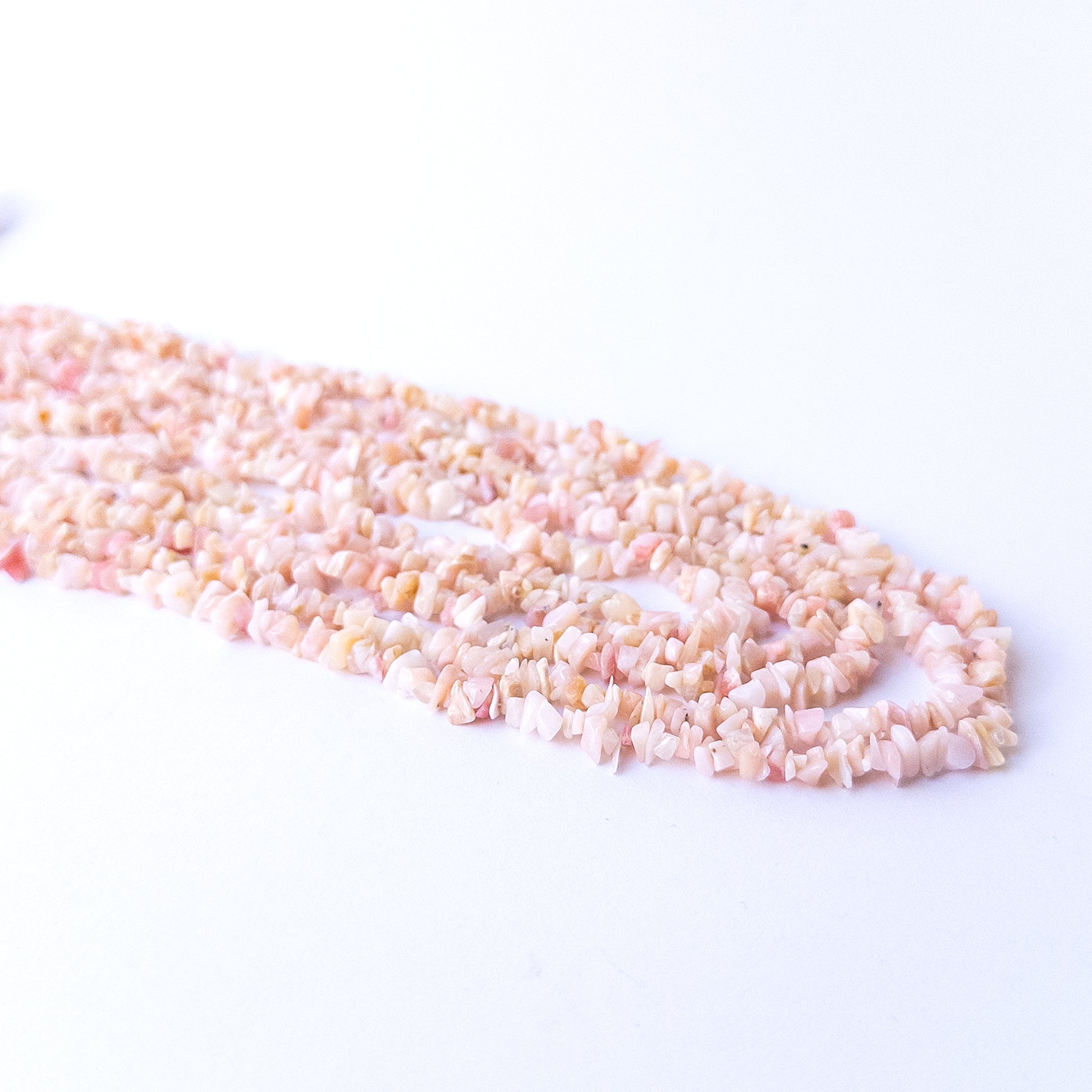 Authentic Pink Peruvian Opal chip beads featuring organic shapes and soothing pink hues.