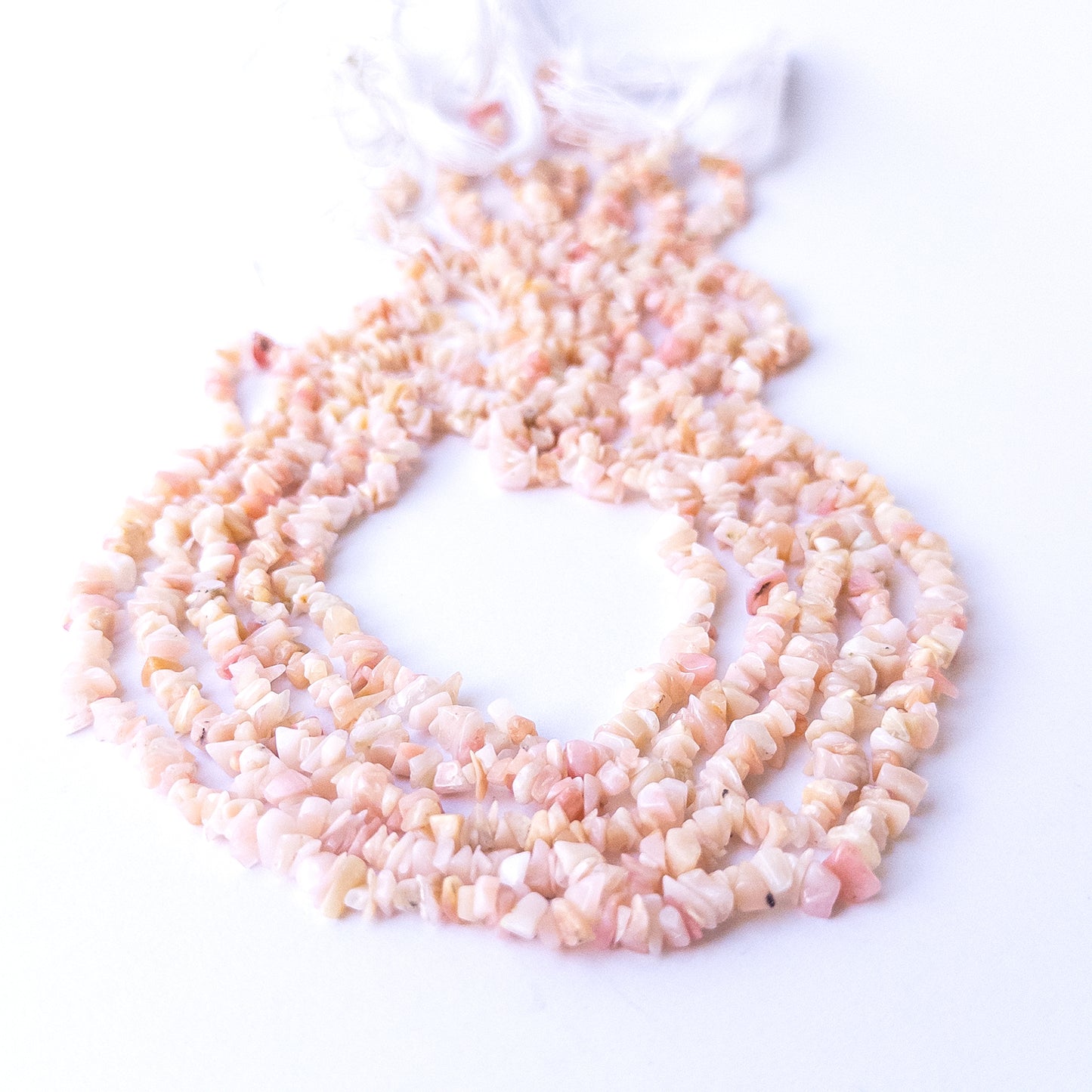 Close‑up of Pink Peruvian Opal gemstone chip beads highlighting natural texture and soft colour variations.