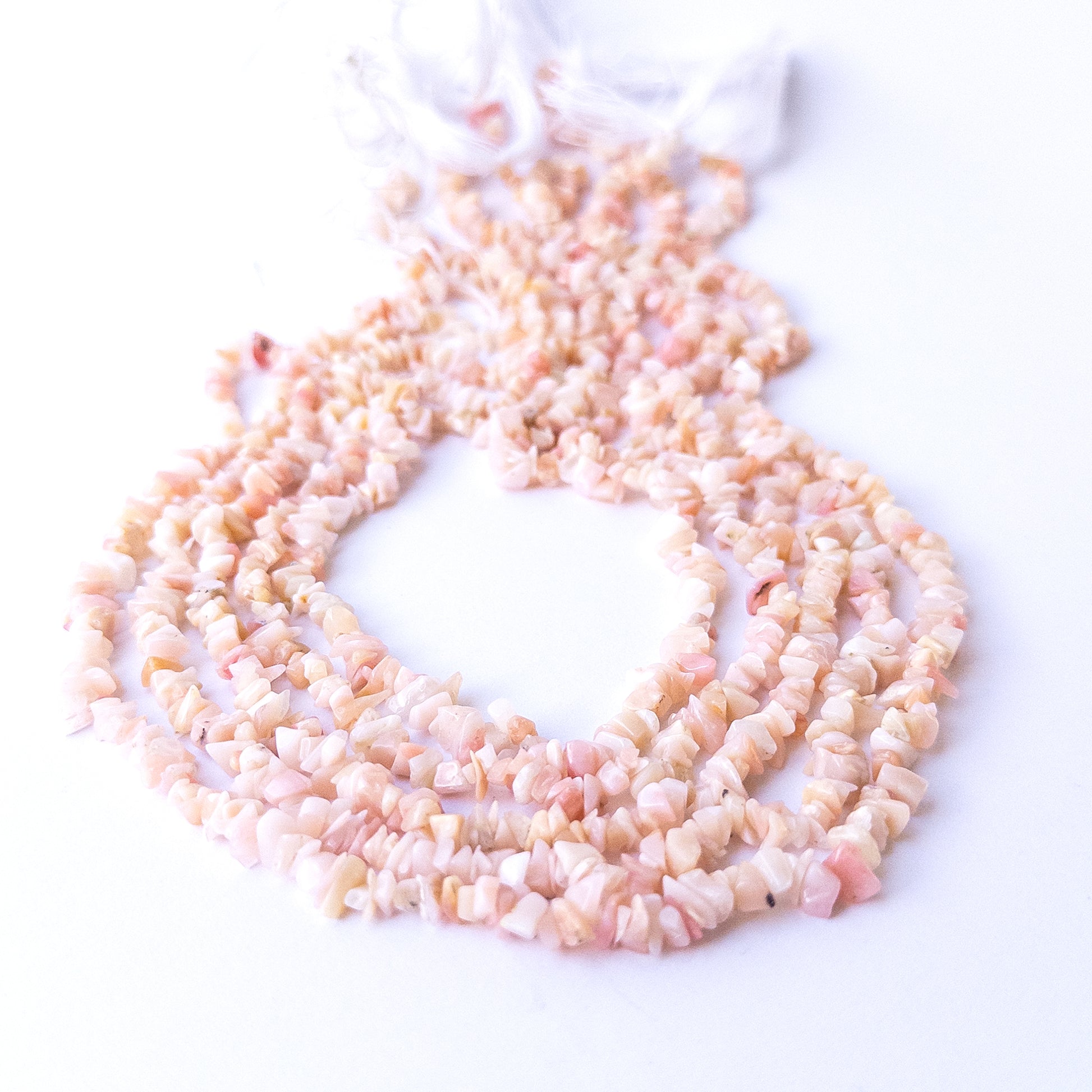 Close‑up of Pink Peruvian Opal gemstone chip beads highlighting natural texture and soft colour variations.