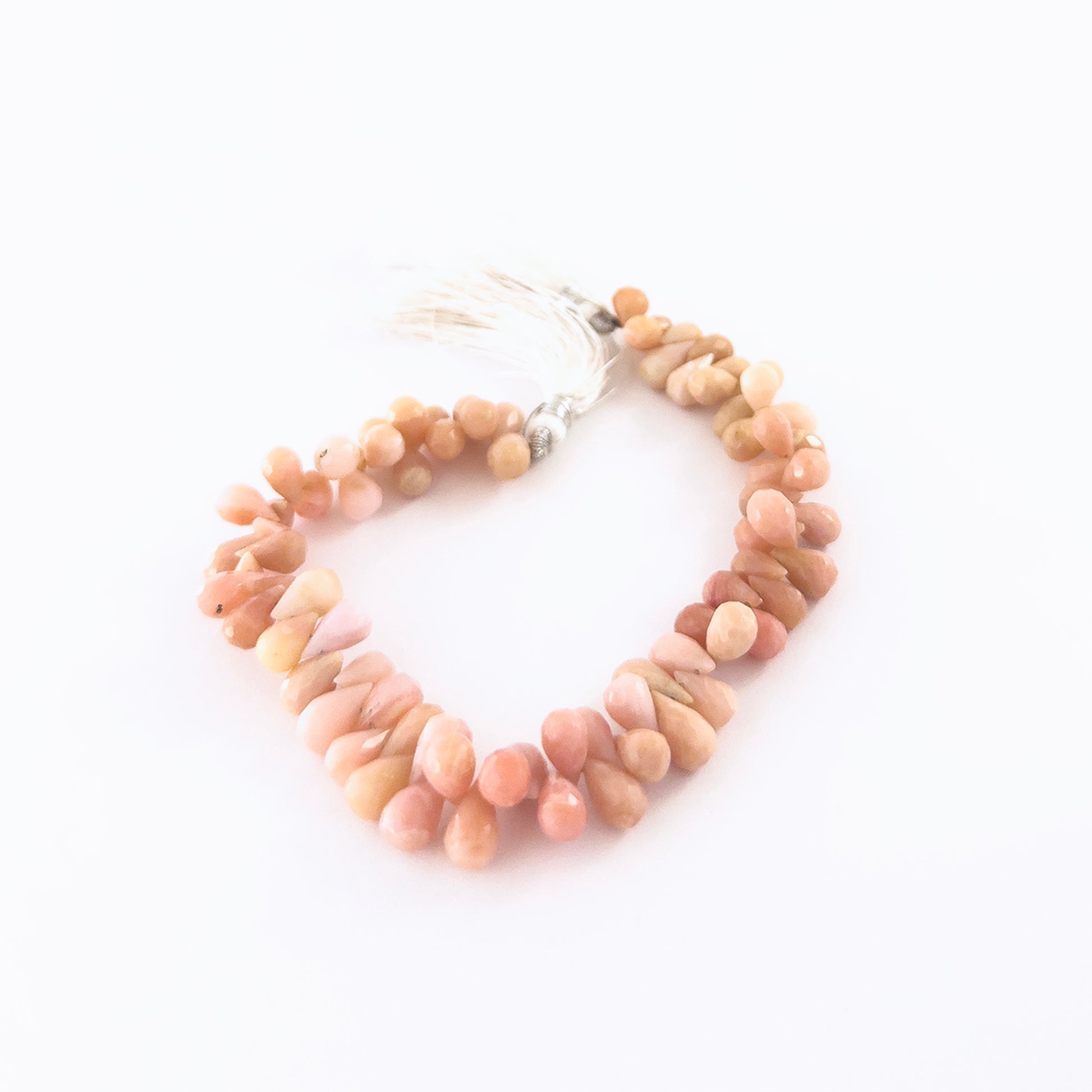 Pink Peruvian Opal gemstones in faceted briolette form, offering bright reflective shine and smooth pastel colouring.