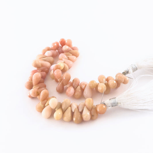 Pink Peruvian Opal faceted briolette gemstones with pastel blush colour and polished brilliance in a 22cm strand.