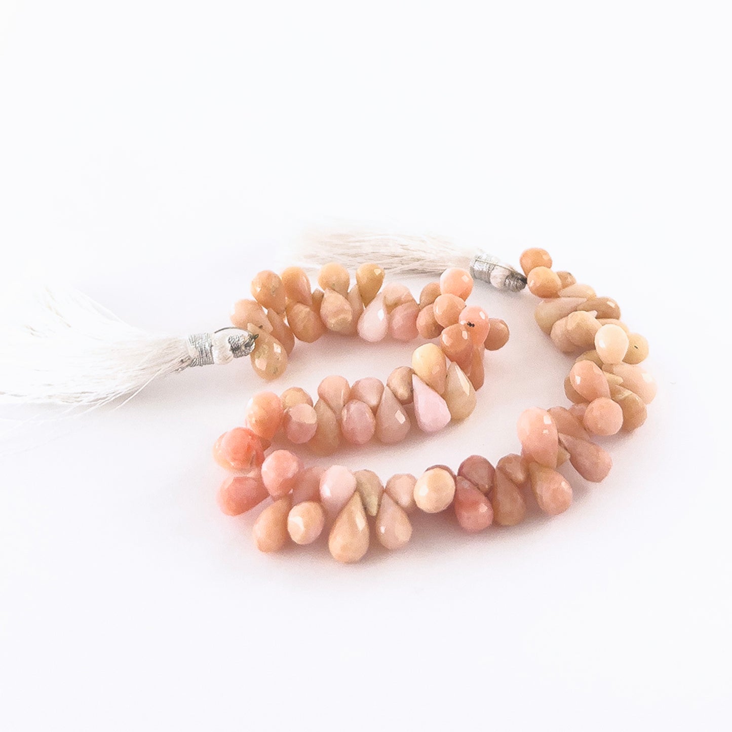 Pink Peruvian Opal faceted briolette beads sized 6–6.5mm arranged in a 22cm strand, showing soft pink tones and sparkling facets.