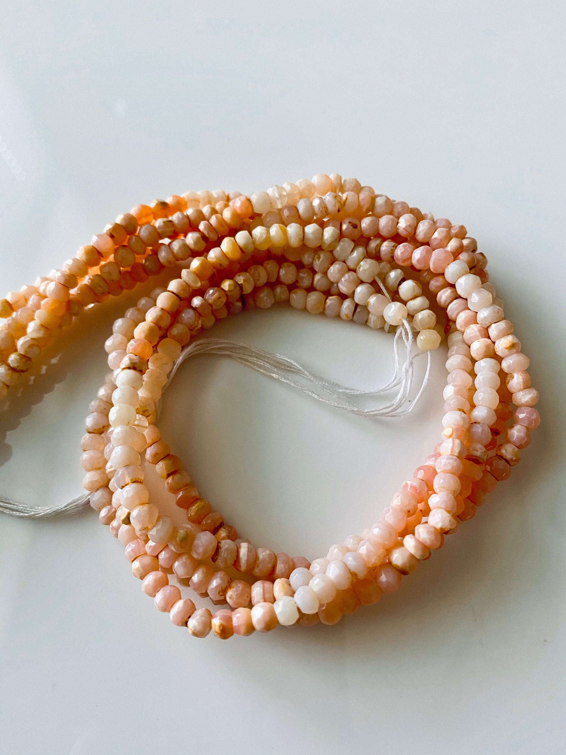 Elegant arrangement of Pink Peruvian Opal beads, highlighting subtle pink variations and clarity.