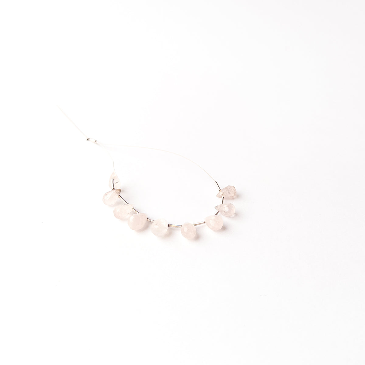 Handmade jewellery components crafted from Pink Quartz briolette beads with a soft luminous appearance.