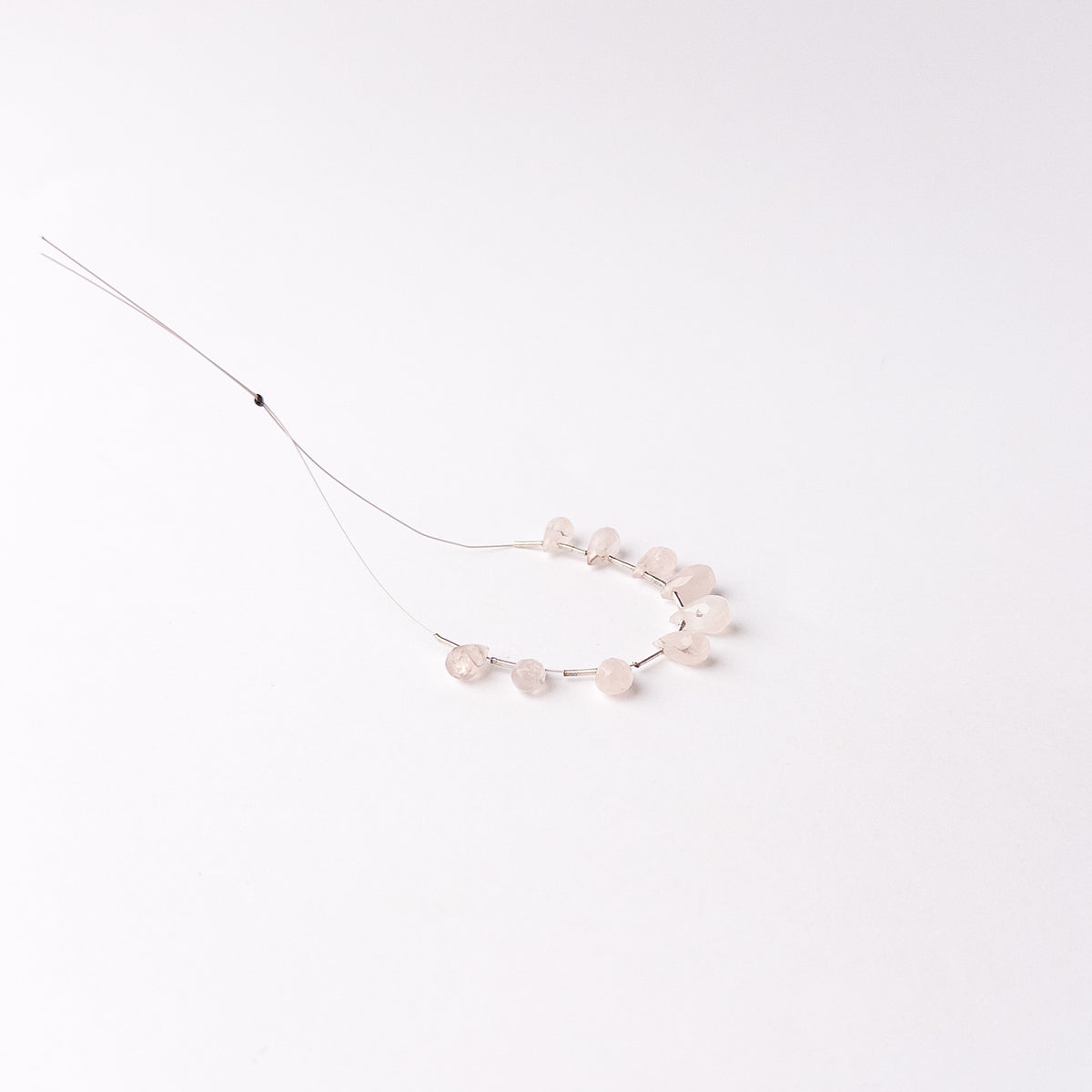 Genuine Pink Quartz gemstone beads arranged as matched briolette pieces with beautiful light-catching facets.