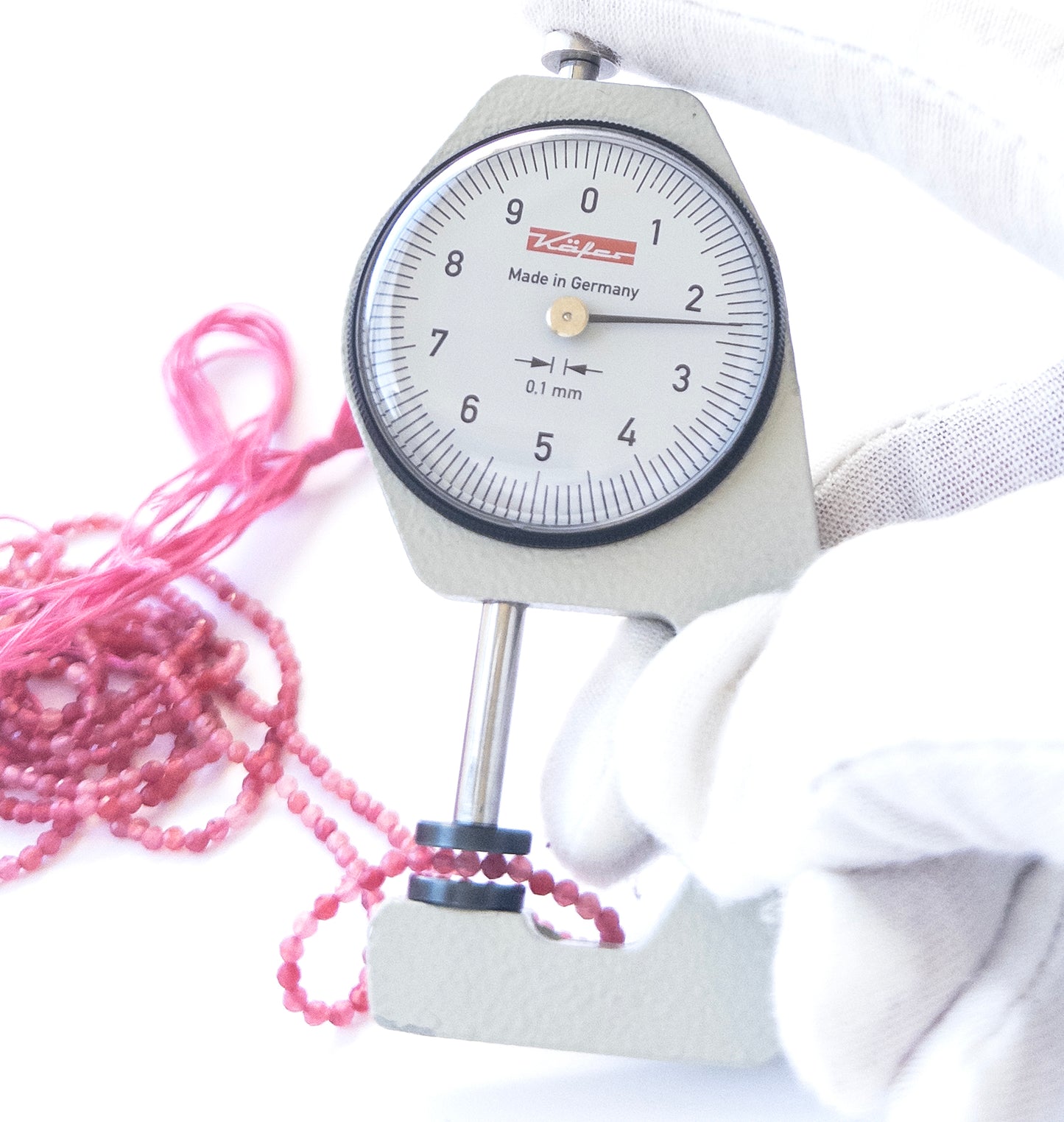 A dial gauge measures the Amethyst faceted rondelle 3.7mm gemstone.