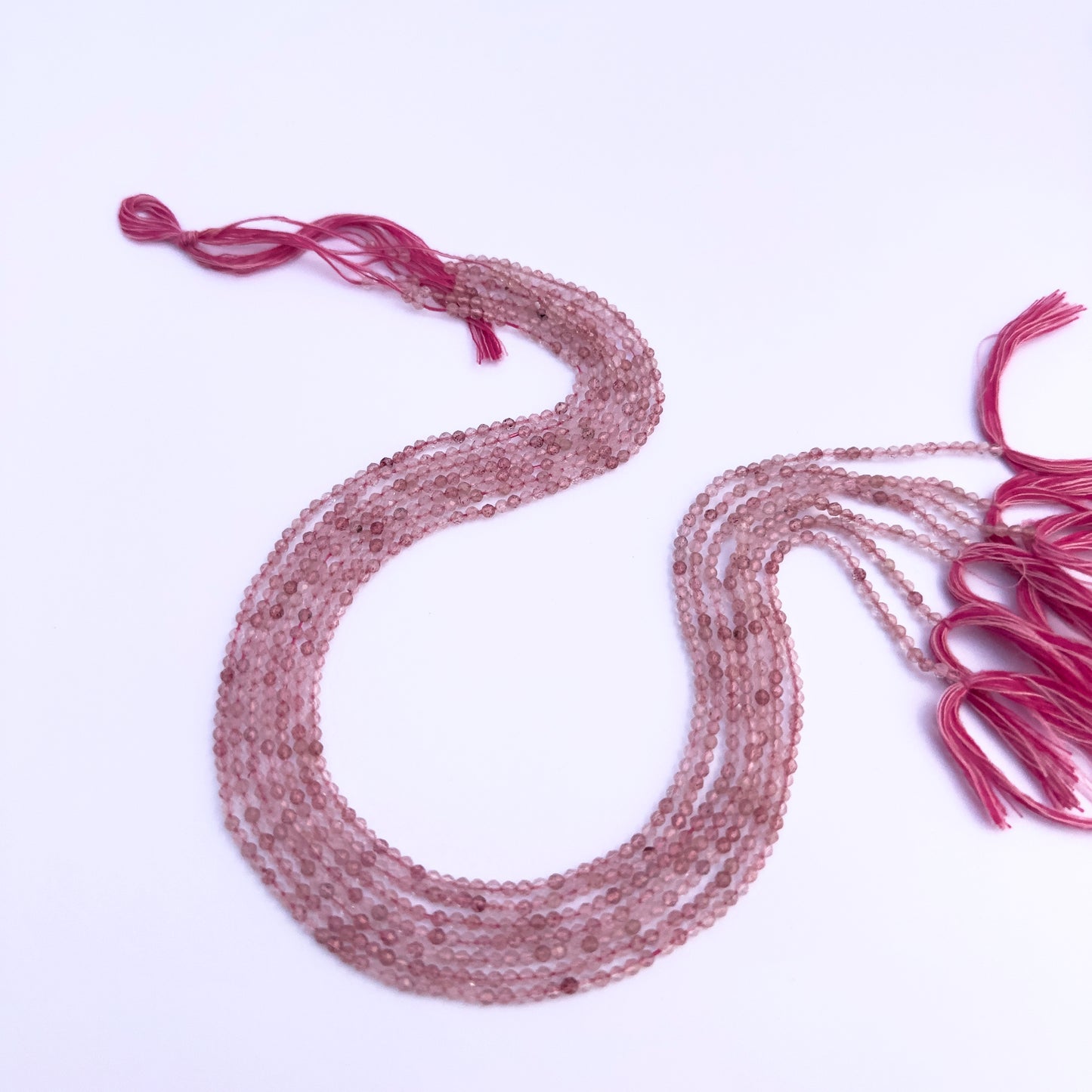 Handmade jewellery components featuring Strawberry Quartz faceted rondelle beads.