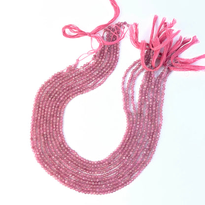 Faceted rondelle Pink Tourmaline beads arranged neatly, highlighting their polished finish and handmade jewellery component quality.