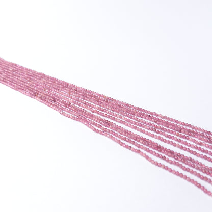 Close‑up of Pink Tourmaline faceted rondelle beads revealing shine, cut and craftsmanship.