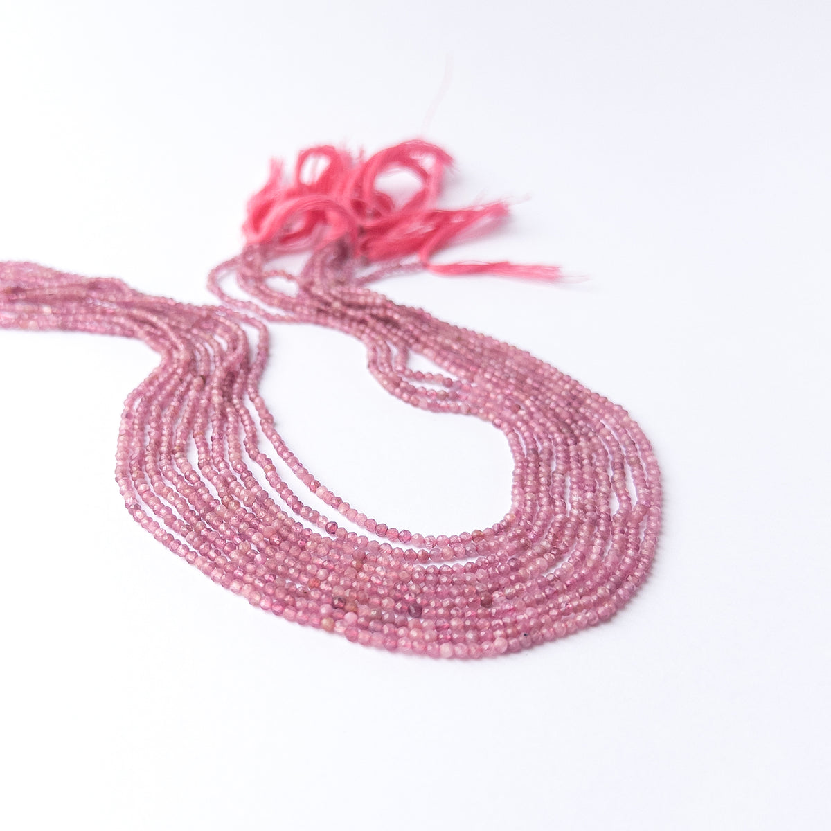 Authentic Pink Tourmaline gemstone beads displaying delicate faceting and vivid rosy clarity.