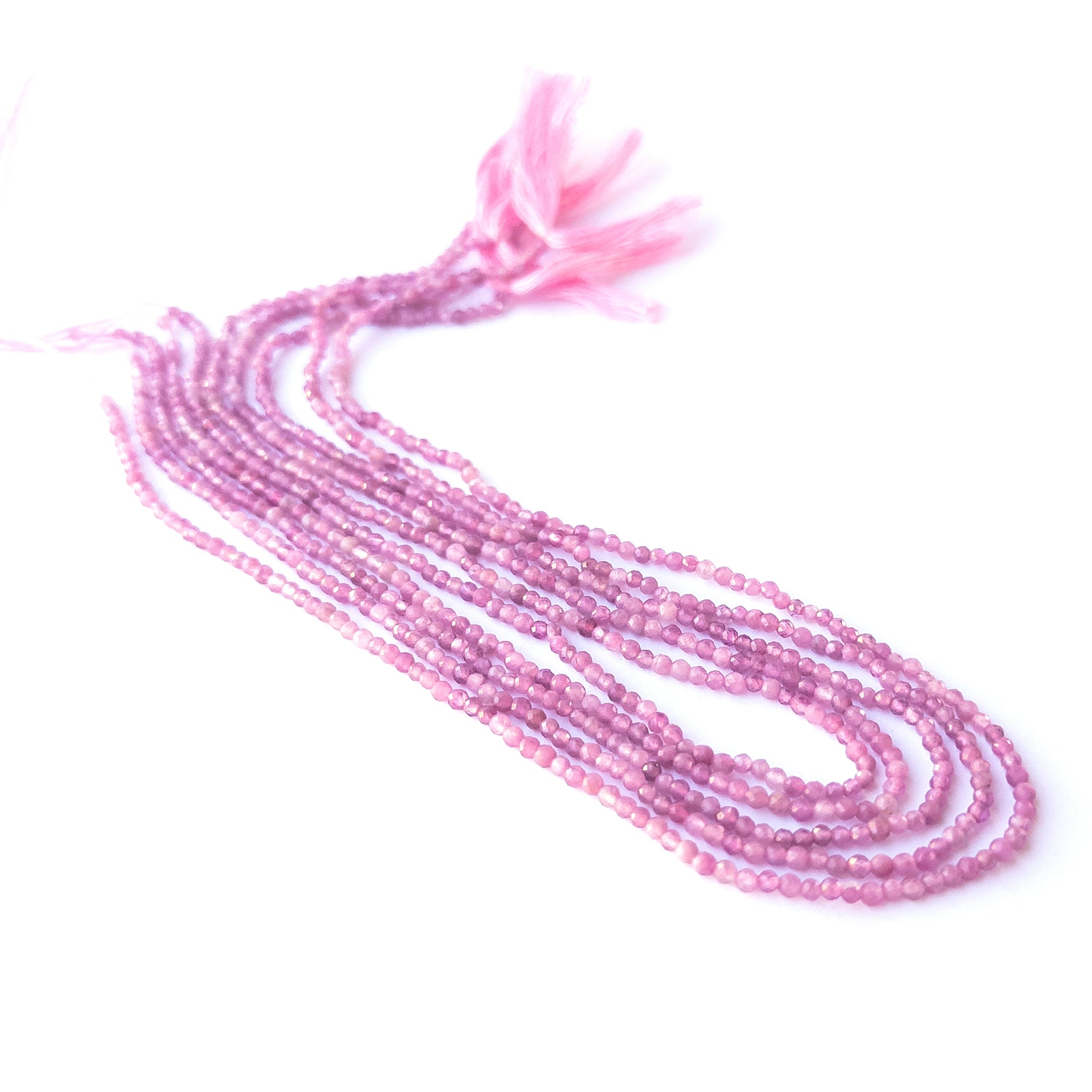 Close‑up of genuine Pink Tourmaline faceted rondelle beads showing their shine, clarity, and delicate 2.4–2.5mm cut.