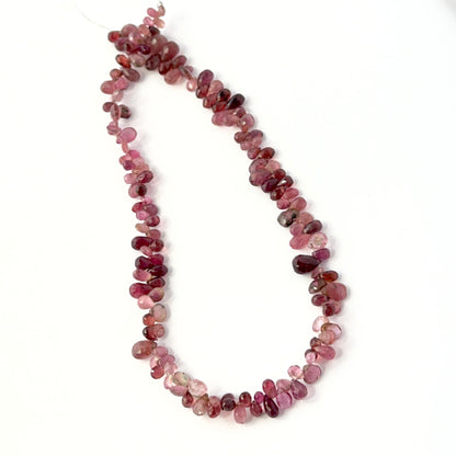 Pink tourmaline briolette beads in 4–8mm x 3–5mm sizes, offering rich colour and quality for gemstone bead projects.