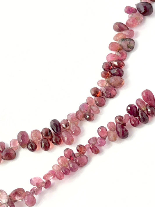 Genuine pink tourmaline stone beads in teardrop briolette cut, showcasing vibrant colour and shine for DIY jewellery.