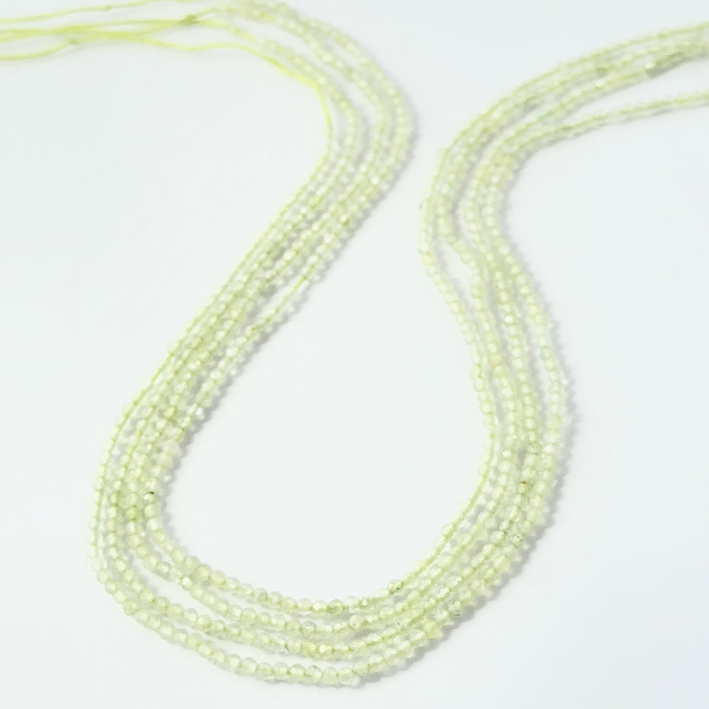 2.2mm faceted Prehnite rondelle beads on a 32cm strand for jewellery making.