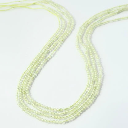2.2mm faceted Prehnite rondelle beads on a 32cm strand for jewellery making.