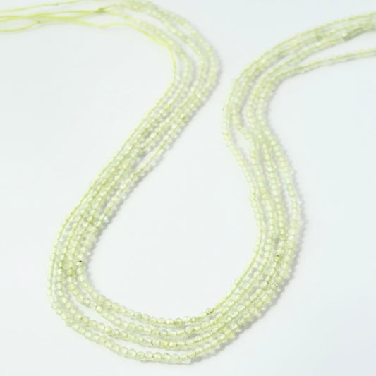 2.2mm faceted Prehnite rondelle beads on a 32cm strand for jewellery making.