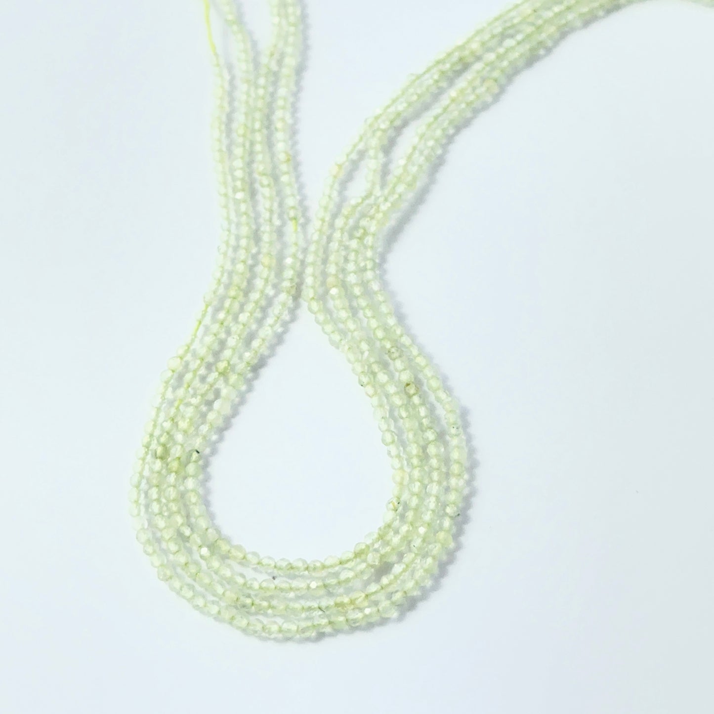 Sparkling Prehnite rondelle beads, 2.2mm size, ideal for necklaces and bracelets.