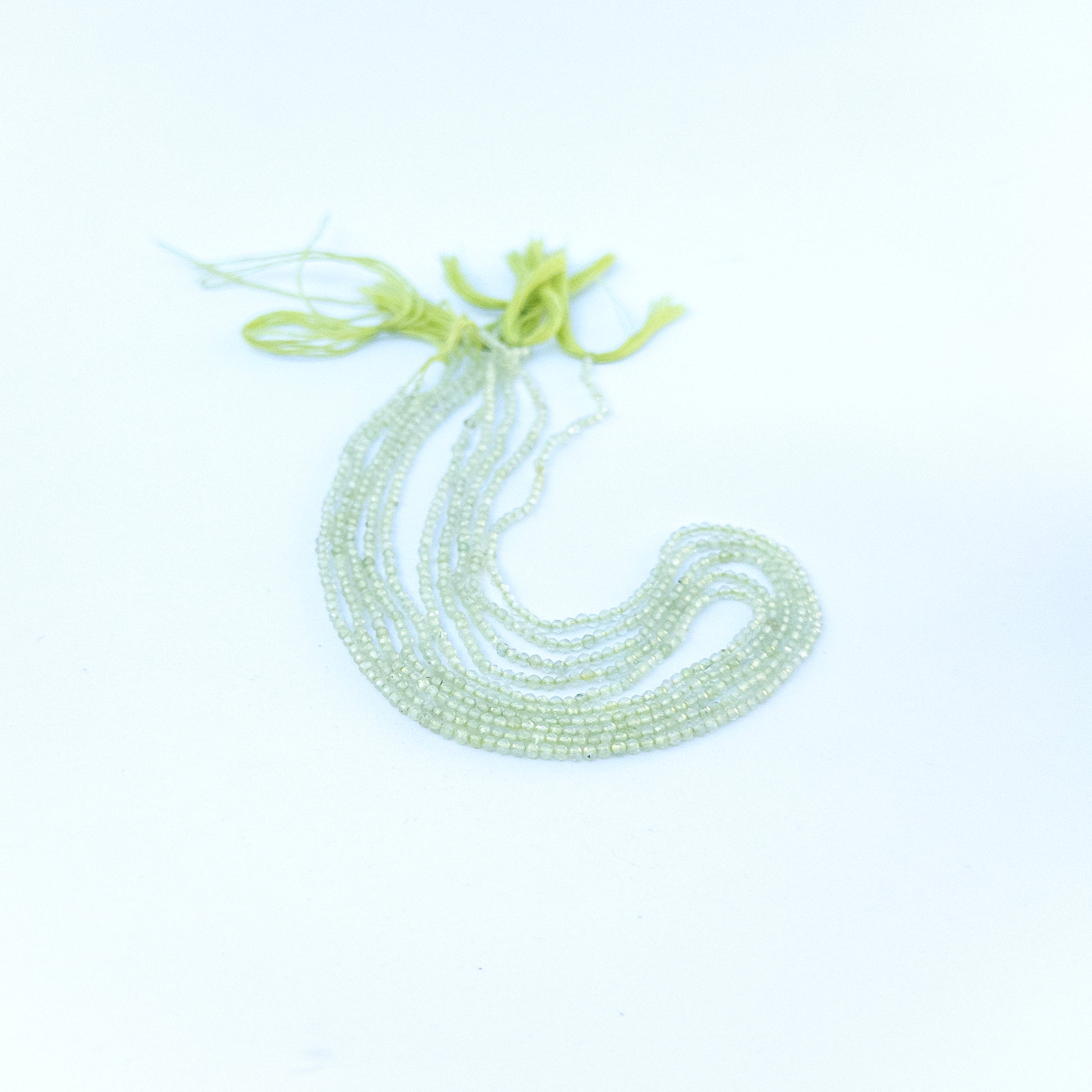 prehnite faceted rondelles displaying pale green colour and quality cut for gemstone beads