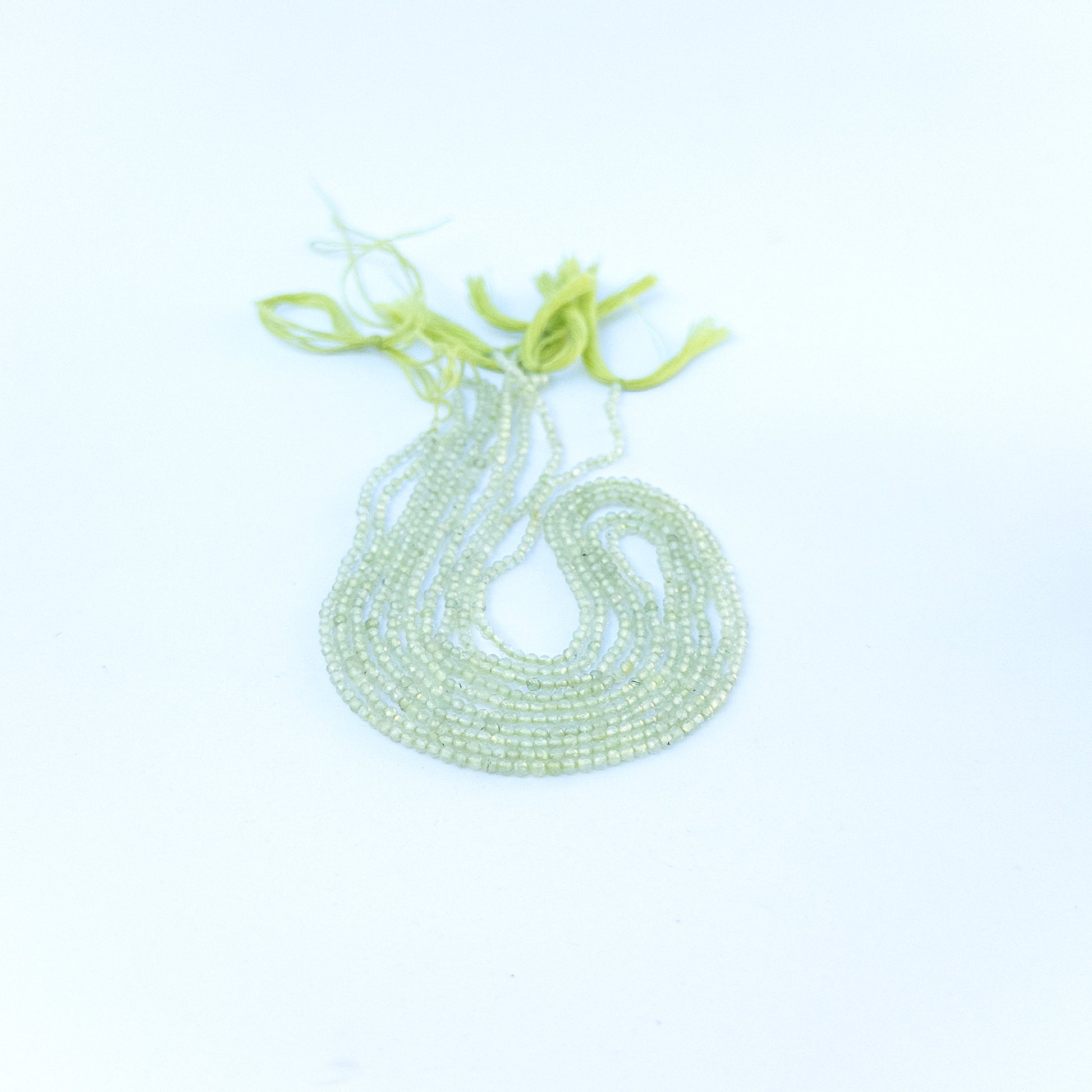 Strand of prehnite faceted rondelles displaying pale green colour and quality cut for gemstone beads for DIY jewellery.