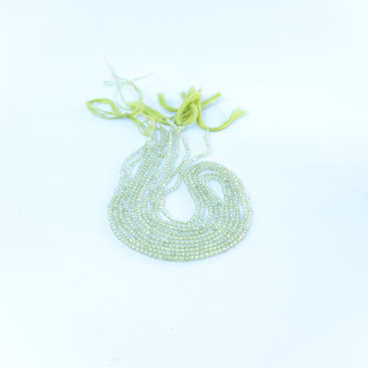 Strand of prehnite faceted rondelles displaying pale green colour and quality cut for gemstone beads for DIY jewellery.