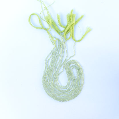 Close‑up of genuine prehnite faceted rondelle gemstone beads with natural glow for DIY jewellery making.