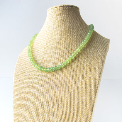 Genuine Prehnite stone beads with crisp faceted rondelle shaping arranged in an elegant necklace.