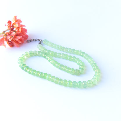 High‑quality faceted rondelle Prehnite beads with polished brilliance and a balanced handcrafted necklace layout.