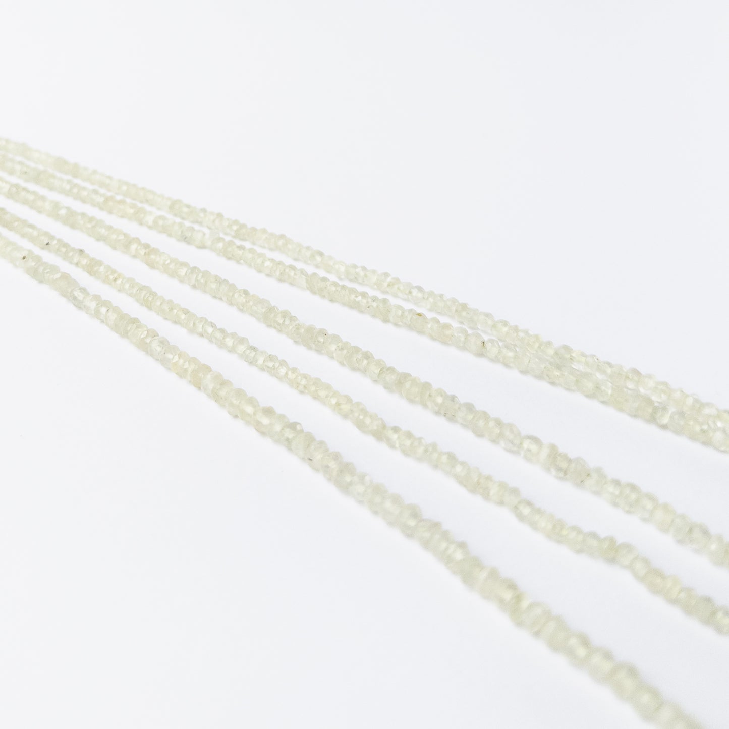Faceted Prehnite rondelle beads with pale green hues, perfect gemstone beads for DIY jewellery making.